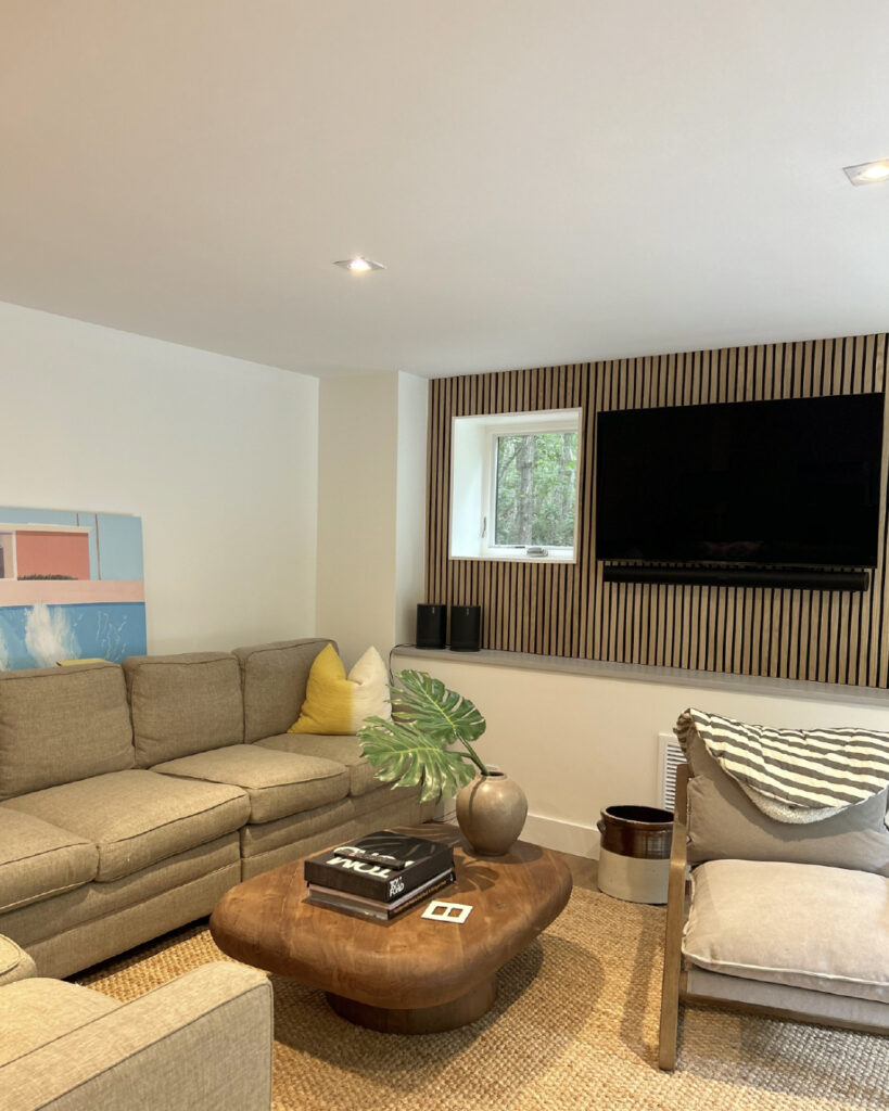 Cozy living room renovation with wooden accent wall and built-in TV – shows the type of transformation often discussed in a Do It Yourself Home Renovation Guide, but requiring expert hands.