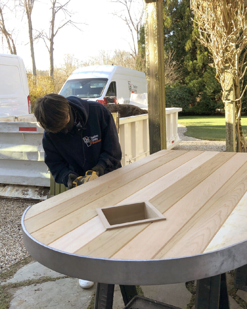 Professional carpenter working on a custom wood table – a reminder that not every task in a Do It Yourself Home Renovation Guide is safe or simple for non-experts.